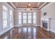 Bright sitting area with fireplace, hardwood floors, bay windows, and access to a balcony, perfect for relaxation at 2740 Bountiful Pl, Lawrenceville, GA 30045