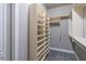 Bright walk-in closet with custom built-in shelving and hanging rods for optimal storage and organization at 2740 Bountiful Pl, Lawrenceville, GA 30045