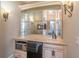 Elegant wet bar with custom cabinetry, mirrored backsplash, microwave, and mini fridge at 2740 Bountiful Pl, Lawrenceville, GA 30045