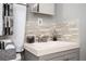 Bathroom featuring a modern vanity, brushed nickel faucet, and stylish backsplash at 3479 Thompson Dr, Atlanta, GA 30331
