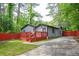 Charming home featuring a freshly painted exterior, a red deck, a driveway, and a nicely landscaped yard at 3479 Thompson Dr, Atlanta, GA 30331