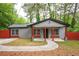 Charming single-story home with gray siding, red accents, covered porch and well manicured lawn at 3479 Thompson Dr, Atlanta, GA 30331