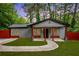 Charming single-story home with gray siding, red accents, covered porch and well manicured lawn at 3479 Thompson Dr, Atlanta, GA 30331