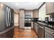 Kitchen featuring stainless steel appliances, dark countertops, and wood floors at 3479 Thompson Dr, Atlanta, GA 30331