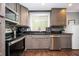 Kitchen featuring stainless steel appliances, dark countertops, and wood floors at 3479 Thompson Dr, Atlanta, GA 30331
