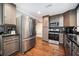 Kitchen featuring stainless steel appliances, dark countertops, and wood floors at 3479 Thompson Dr, Atlanta, GA 30331