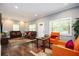 Spacious living area with modern lighting, comfortable seating, hardwood floors, and a decorative area rug at 3479 Thompson Dr, Atlanta, GA 30331