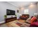 Inviting living room with brown couches, TV, large windows, and area rug at 3479 Thompson Dr, Atlanta, GA 30331