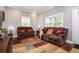 Bright living room features brown sofas, natural light, and a decorative area rug at 3479 Thompson Dr, Atlanta, GA 30331