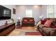 Cozy living room featuring plush brown sofas, modern TV, accent furniture, and a colorful area rug at 3479 Thompson Dr, Atlanta, GA 30331