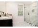 Bathroom featuring marble tiled floors, subway tiled walk-in shower, and black hardware at 523 Mount Zion, Hapeville, GA 30354