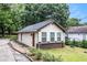 Exterior of house showing a red door, vinyl siding, and brick foundation at 523 Mount Zion, Hapeville, GA 30354