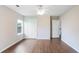 Bedroom features hardwood floors, a ceiling fan, and two entryways at 841 Holly Meadow Dr, Buford, GA 30518