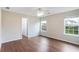 This bedroom features beautiful wood floors, a ceiling fan, and ample natural light from the two windows at 841 Holly Meadow Dr, Buford, GA 30518