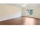 Spacious bedroom with large windows allowing for ample natural light and gorgeous wood flooring at 841 Holly Meadow Dr, Buford, GA 30518
