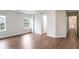 Bright, airy bedroom featuring hardwood floors, two windows, and an adjoining hallway at 841 Holly Meadow Dr, Buford, GA 30518