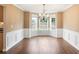 Bright dining area with hardwood floors, wainscoting, and a chandelier at 841 Holly Meadow Dr, Buford, GA 30518