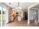 Open kitchen boasts granite counters, stainless appliances, island, and view to backyard through sliding glass doors at 841 Holly Meadow Dr, Buford, GA 30518
