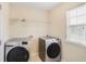 This laundry room is equipped with a modern washer and dryer at 841 Holly Meadow Dr, Buford, GA 30518