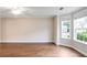 Bright living room with hardwood floors, a ceiling fan, and large windows at 841 Holly Meadow Dr, Buford, GA 30518