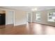 Bright living room with hardwood floors, large windows, and views into other rooms at 841 Holly Meadow Dr, Buford, GA 30518