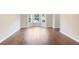 Bright living room featuring beautiful hardwood floors and a large window providing natural light at 841 Holly Meadow Dr, Buford, GA 30518