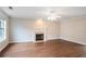 Spacious living room features hardwood floors, fireplace, and a large window at 841 Holly Meadow Dr, Buford, GA 30518