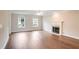 Sun-filled living room with hardwood floors, fireplace, and large windows at 841 Holly Meadow Dr, Buford, GA 30518