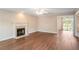 Bright living room featuring hardwood floors, fireplace and a sliding door at 841 Holly Meadow Dr, Buford, GA 30518