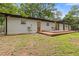 Charming home with a deck, pergola, lush landscaping, and green lawn at 3614 N Druid Hills N Rd, Decatur, GA 30033