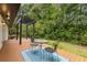 Backyard deck featuring a table with seating with pergola and lush greenery at 3614 N Druid Hills N Rd, Decatur, GA 30033