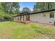 Beautiful home with a wood deck, dark pergola, and a well-maintained lawn at 3614 N Druid Hills N Rd, Decatur, GA 30033