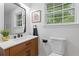 Bright bathroom with a wood vanity, black hardware, and a framed sign at 3614 N Druid Hills N Rd, Decatur, GA 30033