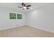 Minimalist bedroom design with a ceiling fan and a window overlooking trees at 3614 N Druid Hills N Rd, Decatur, GA 30033