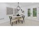 Cozy dining area with a modern chandelier, stylish decor, and doors leading to the outside deck at 3614 N Druid Hills N Rd, Decatur, GA 30033