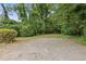 Gravel driveway surrounded by mature trees and natural landscaping at 3614 N Druid Hills N Rd, Decatur, GA 30033
