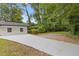 An expansive driveway beside a well-maintained white ranch style home at 3614 N Druid Hills N Rd, Decatur, GA 30033