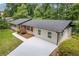 Charming home features a dark roof, fresh white siding, and a driveway at 3614 N Druid Hills N Rd, Decatur, GA 30033