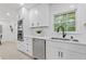 Well-lit kitchen with stainless steel appliances, marble backsplash, white cabinets, and integrated double ovens at 3614 N Druid Hills N Rd, Decatur, GA 30033