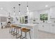 Bright, modern kitchen features an island with seating, stainless steel appliances, and a sleek, white design at 3614 N Druid Hills N Rd, Decatur, GA 30033