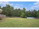 Large backyard with a wooded area and an above ground pool, surrounded by a wooden fence at 385 Eagles Nest Cir, Carrollton, GA 30116