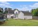 Large backyard with a patio, outdoor seating, grill, fire pit, and trampoline/slide at 385 Eagles Nest Cir, Carrollton, GA 30116