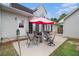 Relaxing backyard patio with table, chairs, umbrella, and house with many windows in the background at 385 Eagles Nest Cir, Carrollton, GA 30116