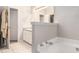 Bright bathroom featuring a soaking tub and a separate vanity with good storage at 385 Eagles Nest Cir, Carrollton, GA 30116
