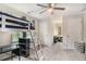 This bedroom features carpet, a bunk bed, desk, ceiling fan, and two windows to allow natural light in at 385 Eagles Nest Cir, Carrollton, GA 30116