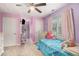 Brightly-painted bedroom with ceiling fan, carpet flooring, and large windows at 385 Eagles Nest Cir, Carrollton, GA 30116