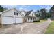 View of home with attached two-car garage and basketball hoop and long driveway at 385 Eagles Nest Cir, Carrollton, GA 30116