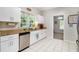 Kitchen featuring stainless steel dishwasher, granite countertops, white cabinets, and tile floors at 385 Eagles Nest Cir, Carrollton, GA 30116