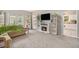 Bright living room with fireplace, built-in shelving and view into kitchen at 385 Eagles Nest Cir, Carrollton, GA 30116