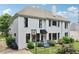 Two-story home features a basketball hoop and manicured lawn, creating a welcoming outdoor space at 4085 Hillcrest View Ct, Suwanee, GA 30024